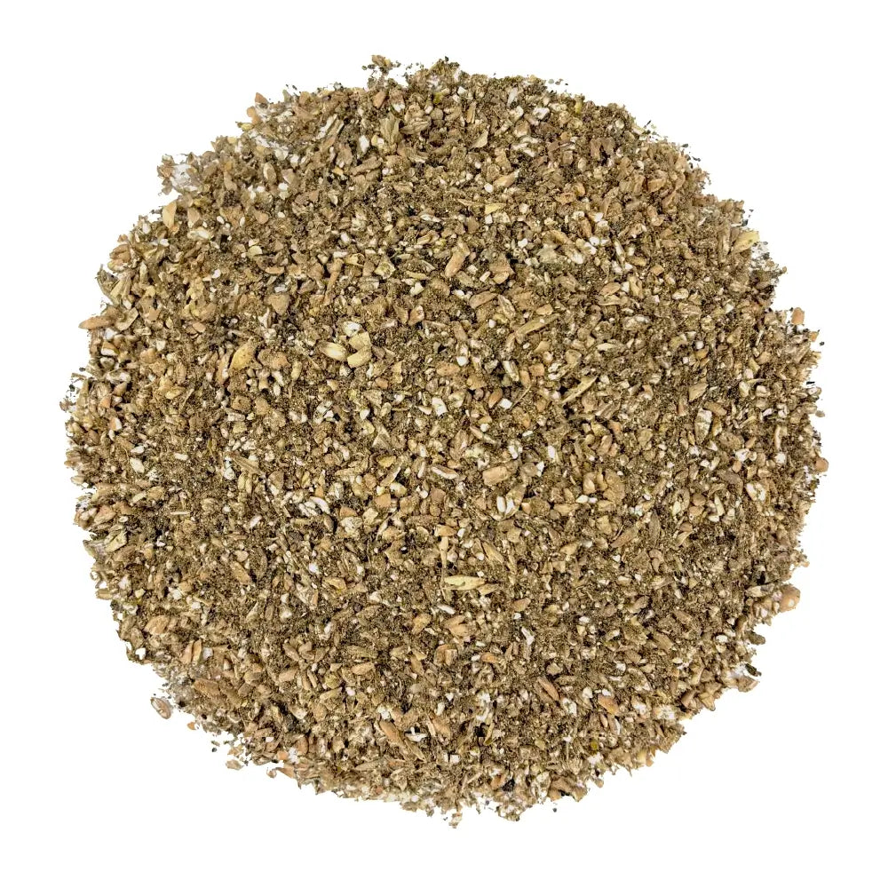 A circular pile of coarse ground coffee beans with visible bean fragments and dark roasted bits, photographed from directly above on a plain white background.