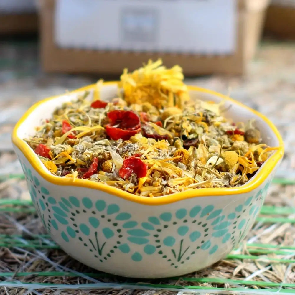 Pampered Chicken Mama organic nesting herbs packaging with dried flowers on a white background