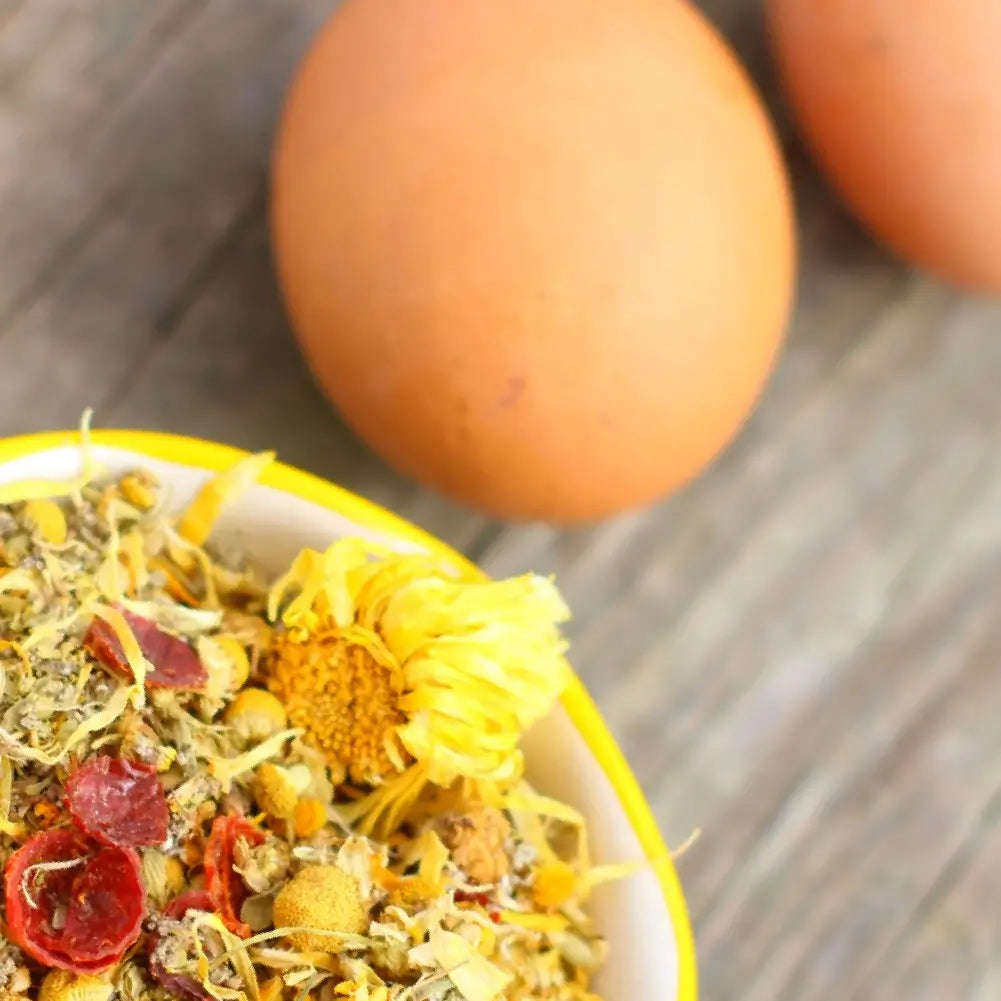 Pampered Chicken Mama organic nesting herbs packaging with dried flowers on a white background